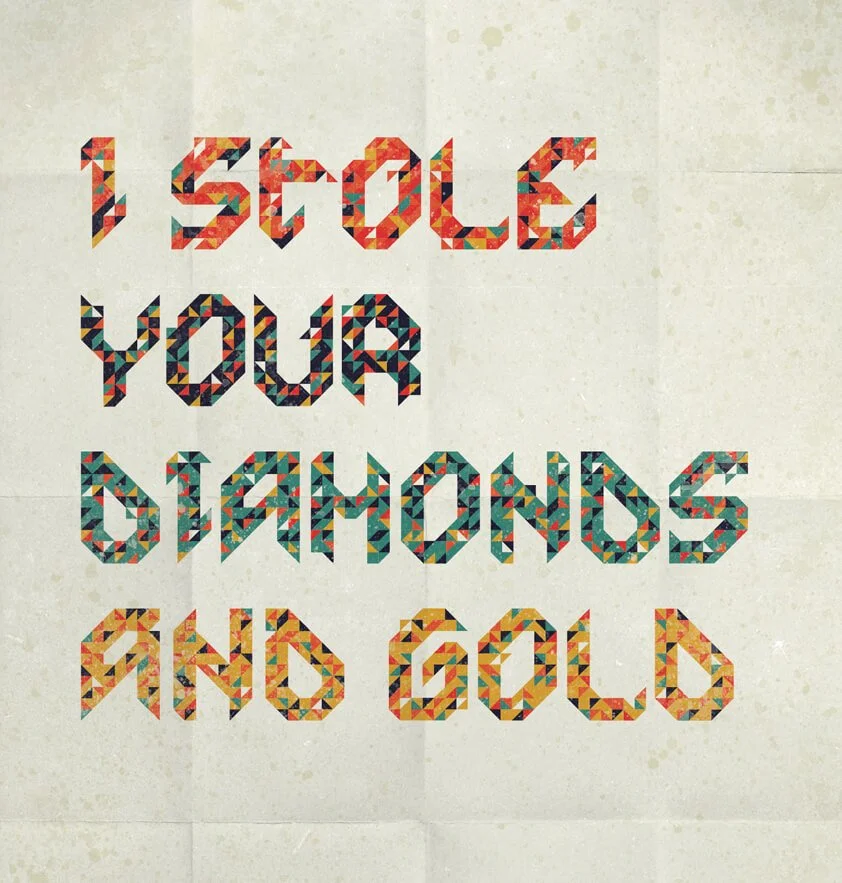 Colorful mosaic text on a beige wall reads, "I SCARE YOU, DIAMONDS AND GOLD."