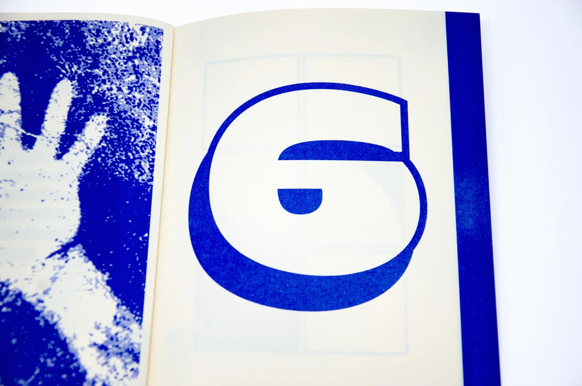 Page from a book featuring a blue and white basketball court illustration on the right and a blue and white textured abstract design on the left.