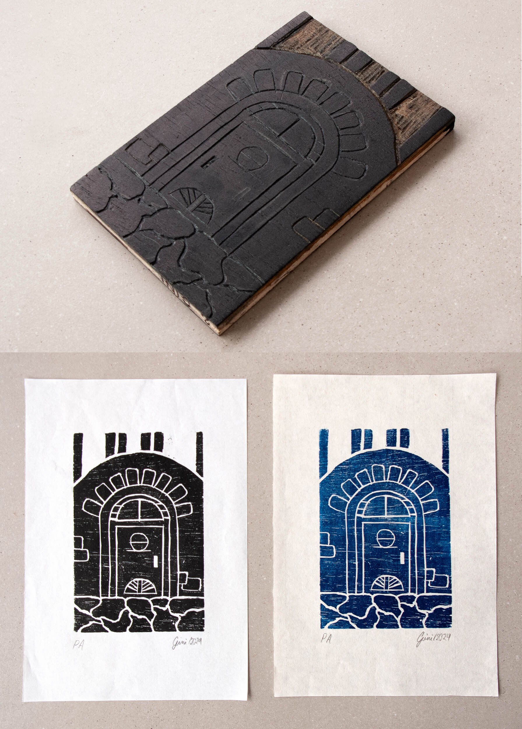 Photograph of a black woodcut with a door and window design, and two prints of the stamped image in black and blue ink on white paper.