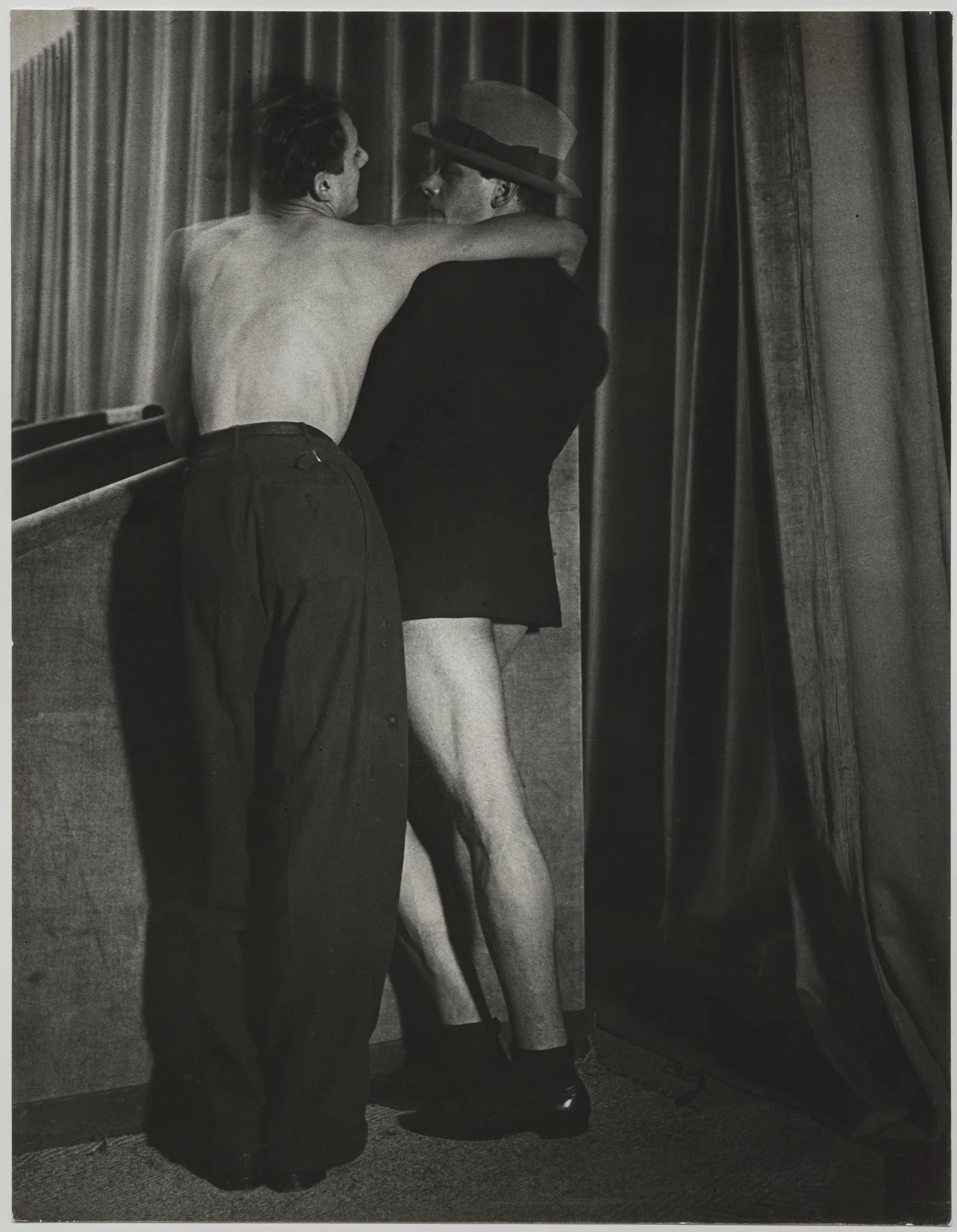  Brassaï (Gyula Haláz) (French, born in Hungary, 1899–1984), Young Couple Wearing a Two-in-One Suit at the Bal de la Montagne Sainte- Geneviève, c. 1931, Printed 1950s, Gelatin silver print, ferrotyped,
11 1⁄2 × 9 1⁄2 inches
Inscriptions
Signed and d