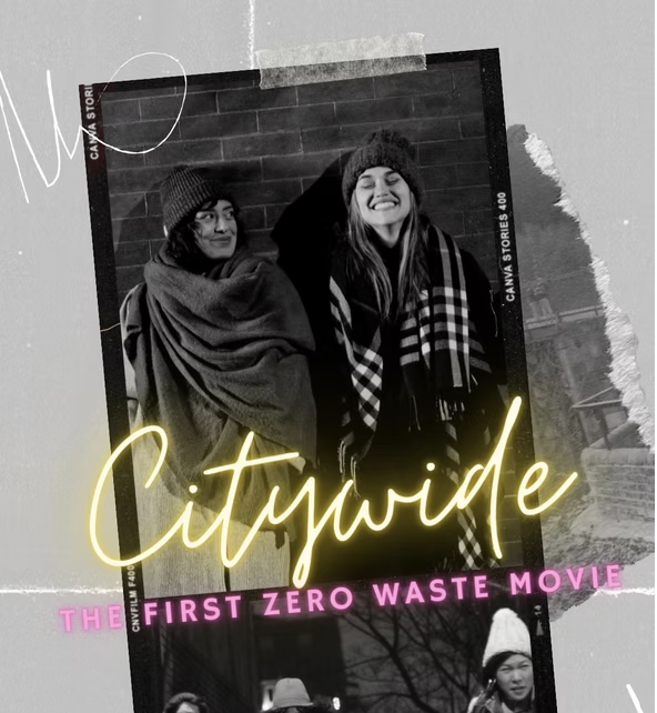 Two women smiling outdoors in winter clothing, with a brick wall background, overlaid with colorful text that says 'Citywide', 'The first zero waste movie' in pink, and a blurred background with trees and buildings.