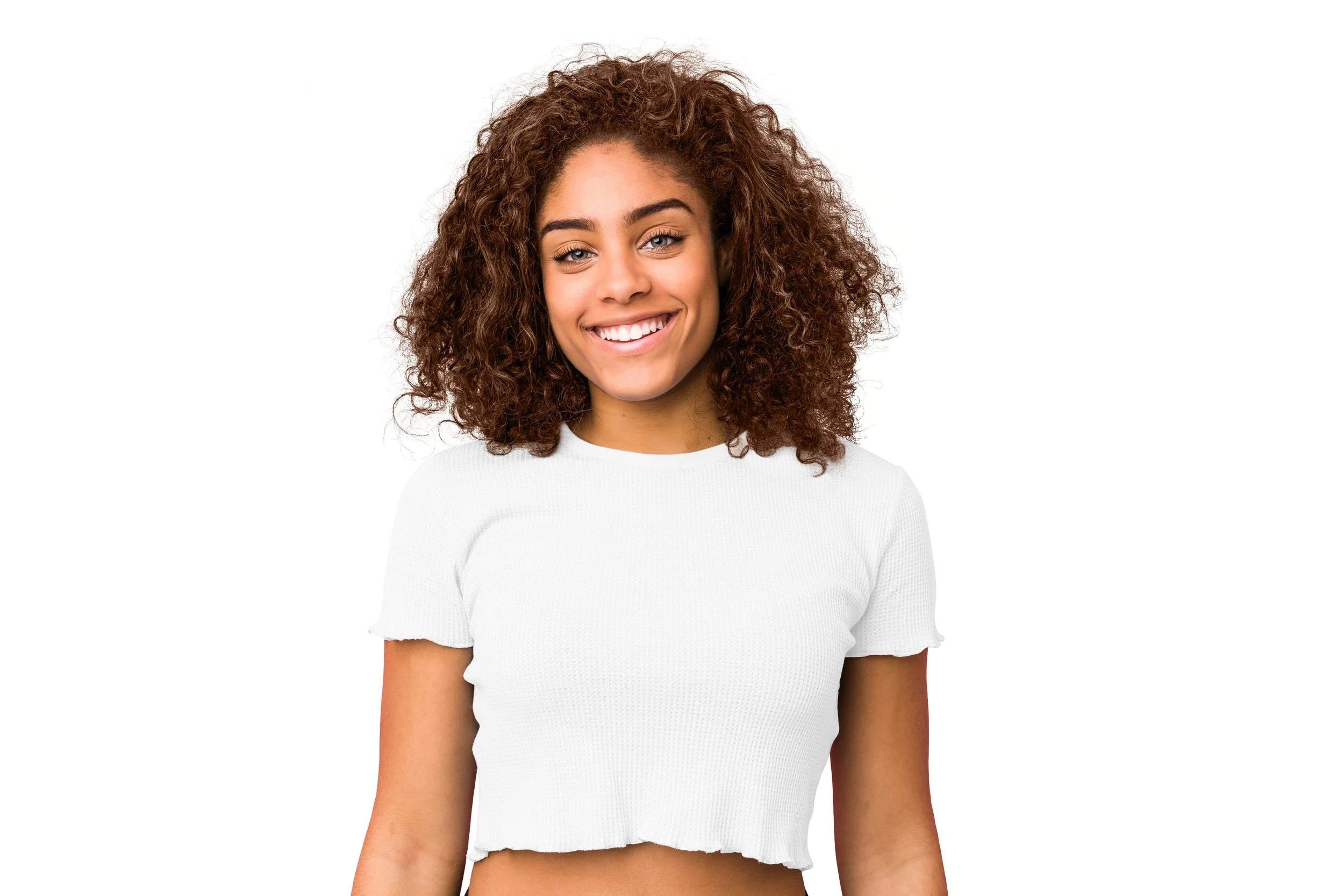 Close-up of a young woman with curly brown hair smiling against a white background.