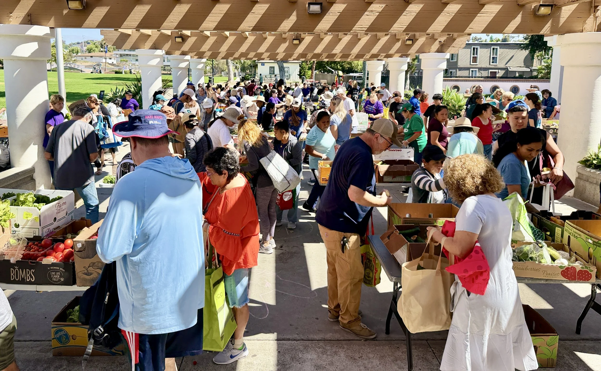 Crowd of people shopping at the free farmers market