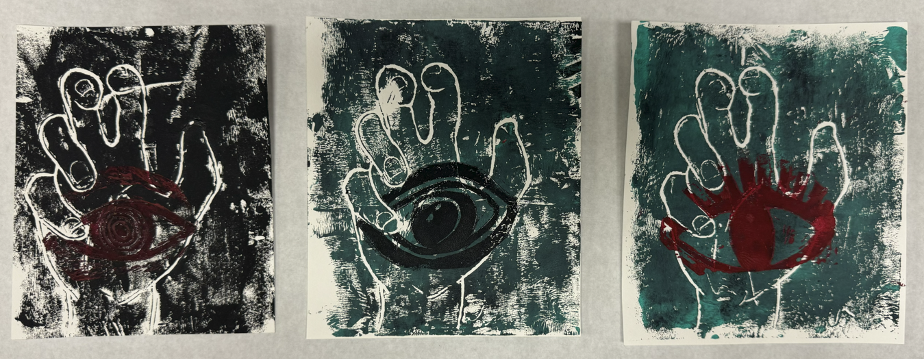 Three art prints depicting hands with an eye inside the palm, each with a different background color and style.