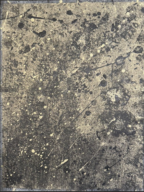 Close-up of a textured, speckled, and stained concrete or stone surface with black and beige random patterns.