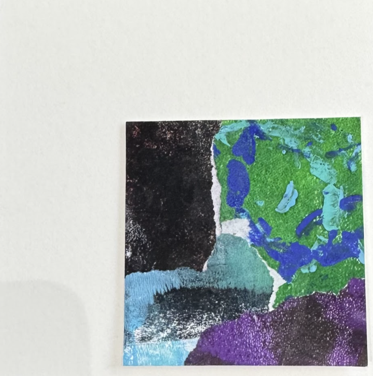 Colorful abstract art with black, green, blue, and purple areas on a white background.