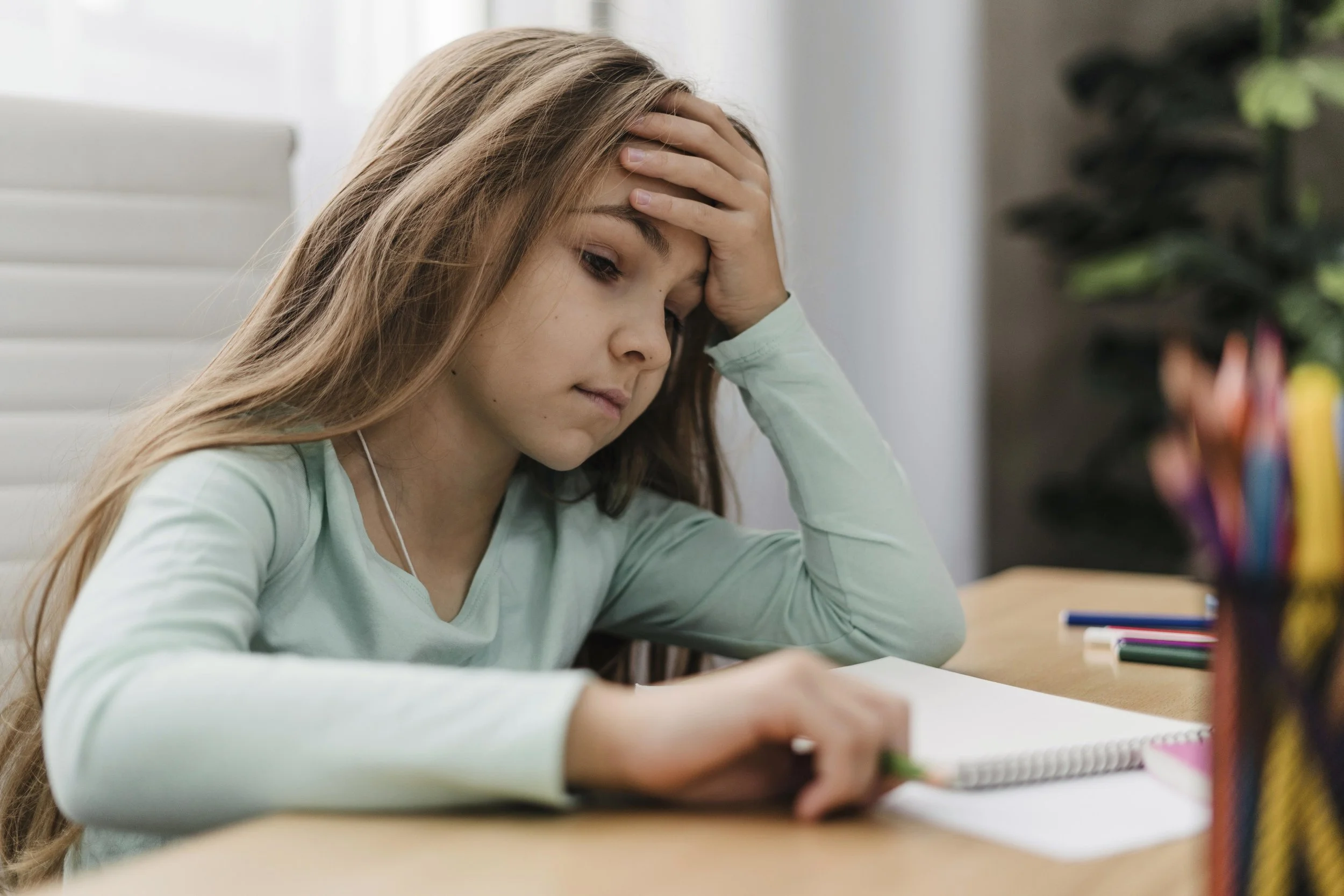 Jeune fille qui a du mal à faire ses devoirs
