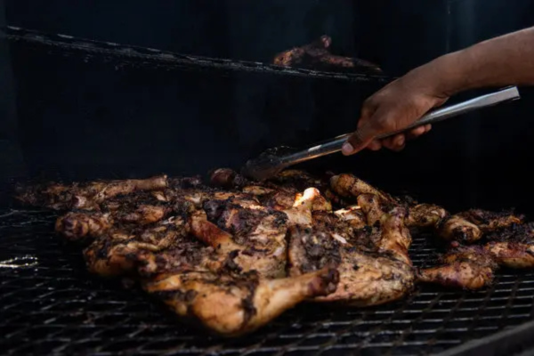 Chicken being jerked on in outside grill