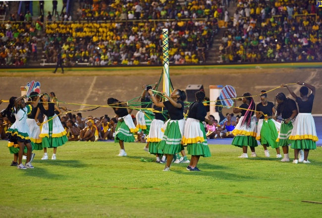 Independence day celebration at stadium dancers performing on the field.