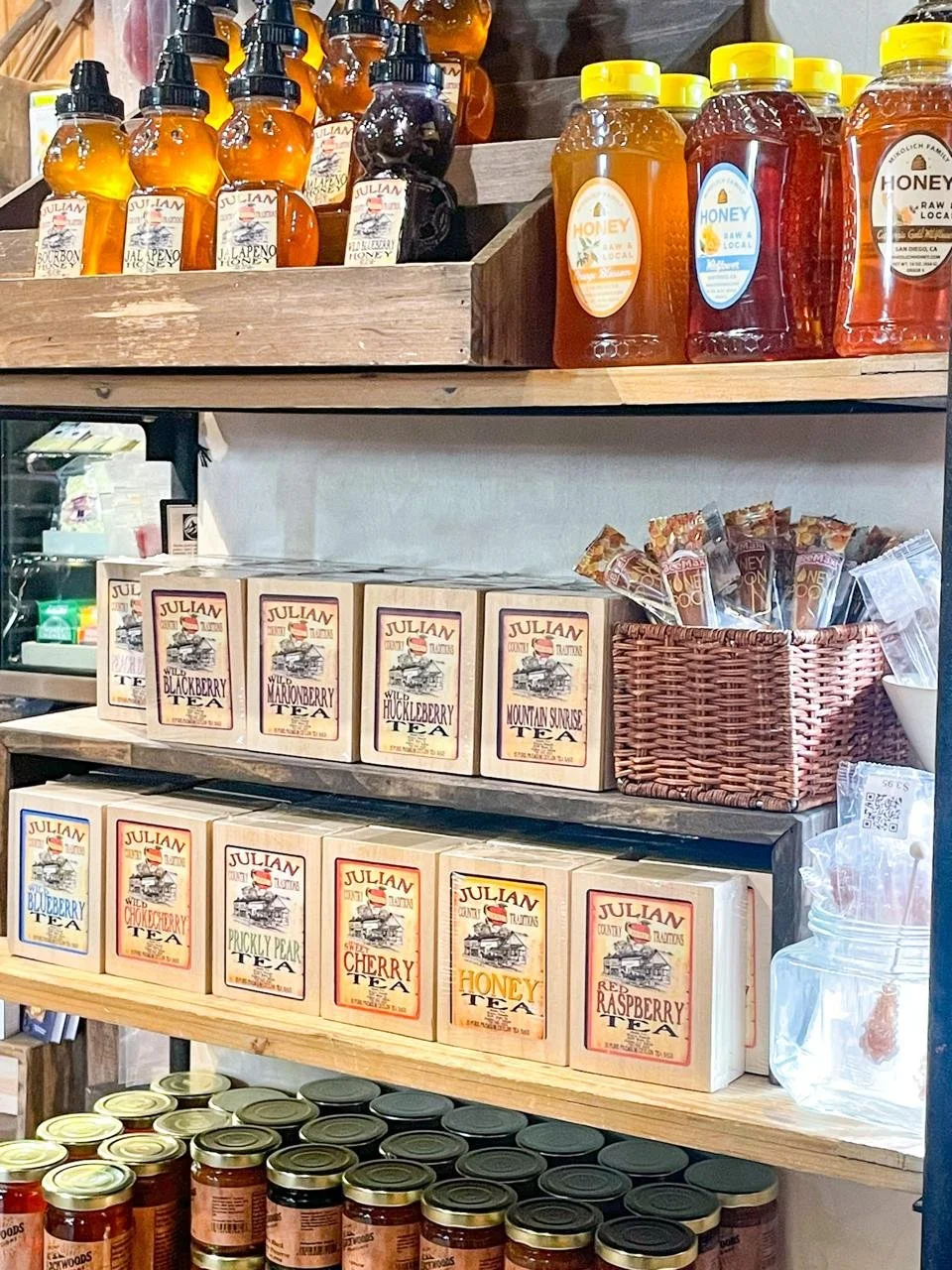 Local honey and Julian Country Traditions tea on wooden shelves at The Warm Hearth in Julian California