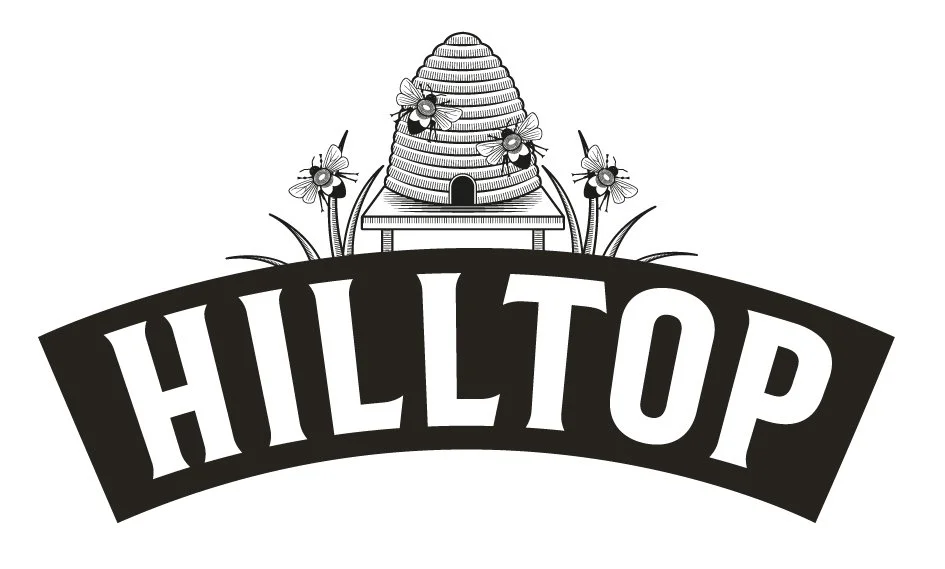 Illustration of a beehive on a stand, surrounded by flowers with the word 'HILLTOP' in bold capital letters beneath.