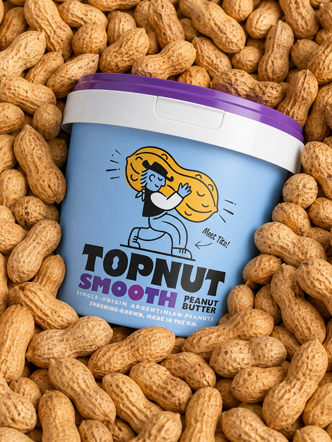A container of Topnut Smooth peanut butter surrounded by peanuts.