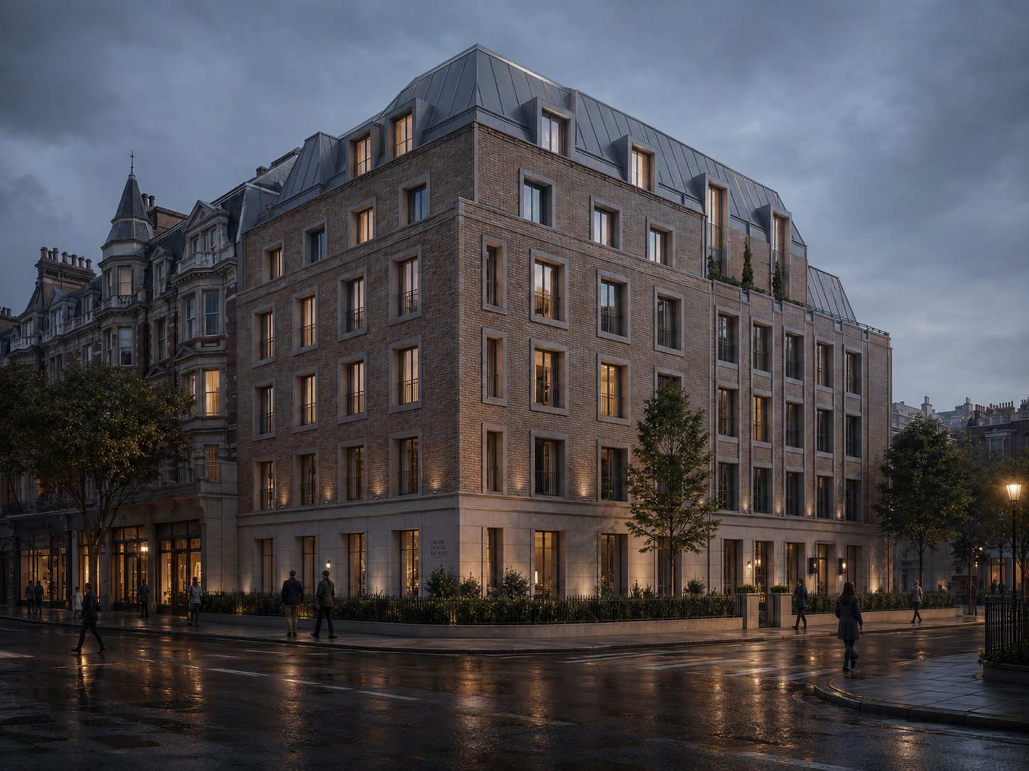 A modern multi-story building with large windows and a brick facade, illuminated at dusk on a rainy city street with pedestrians and streetlights.