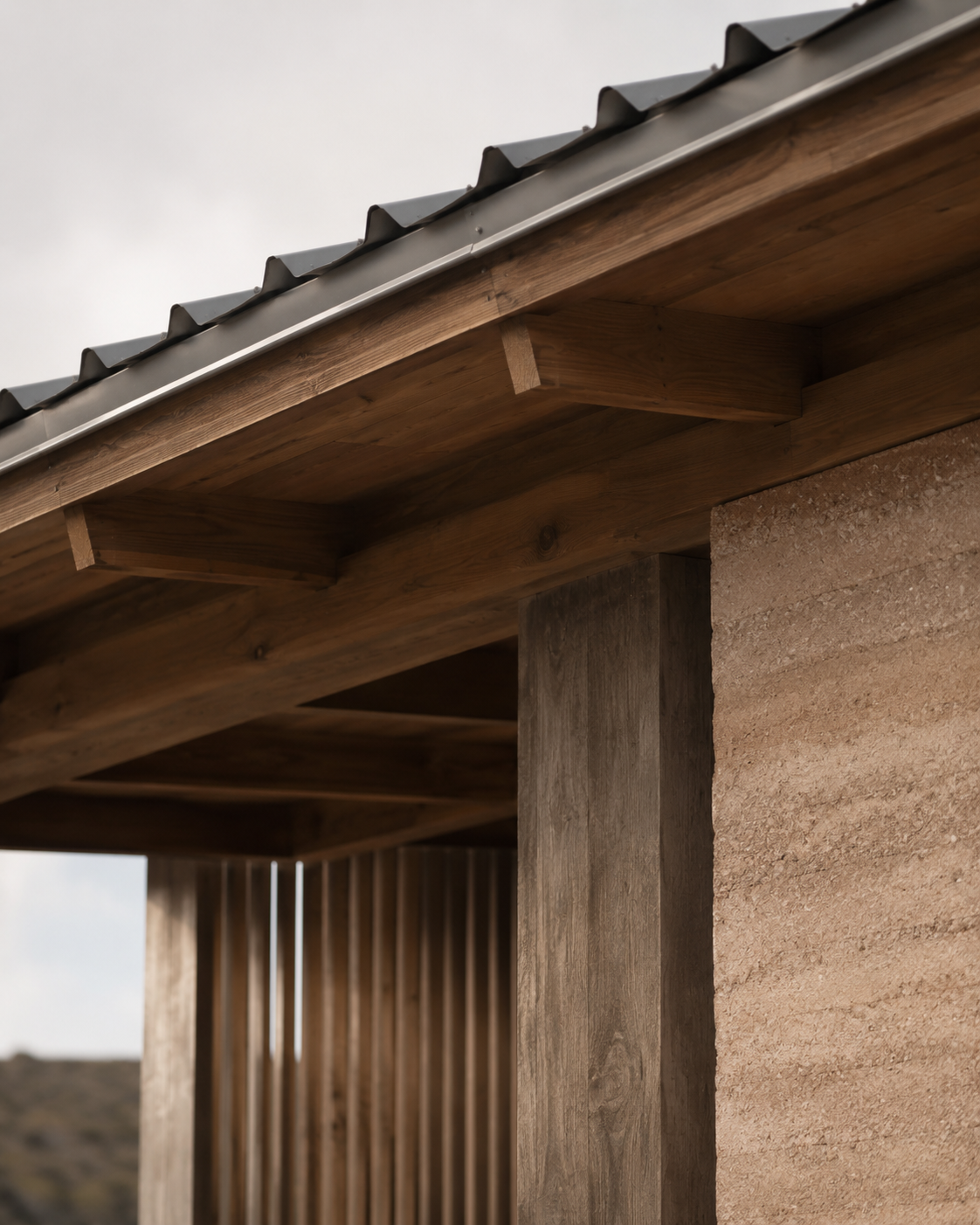 Close-up of a wooden roof overhang and a brick wall on a building, showing the construction details.