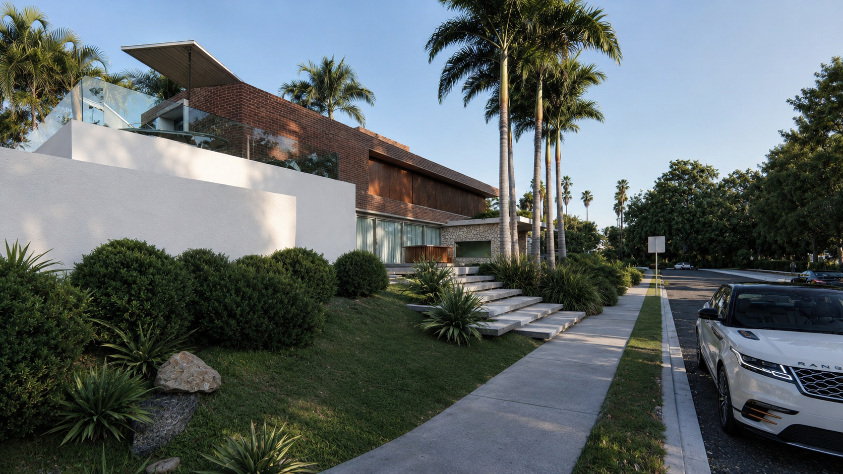 Projeto residencial moderno com fachada em tijolo aparente, grandes aberturas em vidro e integração entre arquitetura e natureza.