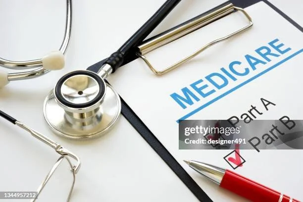 Medical documentation with a stethoscope, pen, and healthcare forms labeled 'Medicare' and checkboxes.