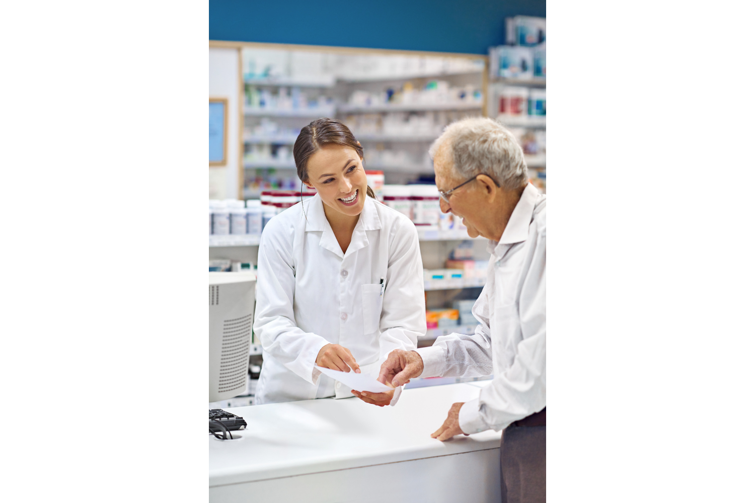 Pharmacist helping a Medicare beneficiary with prescription medications.