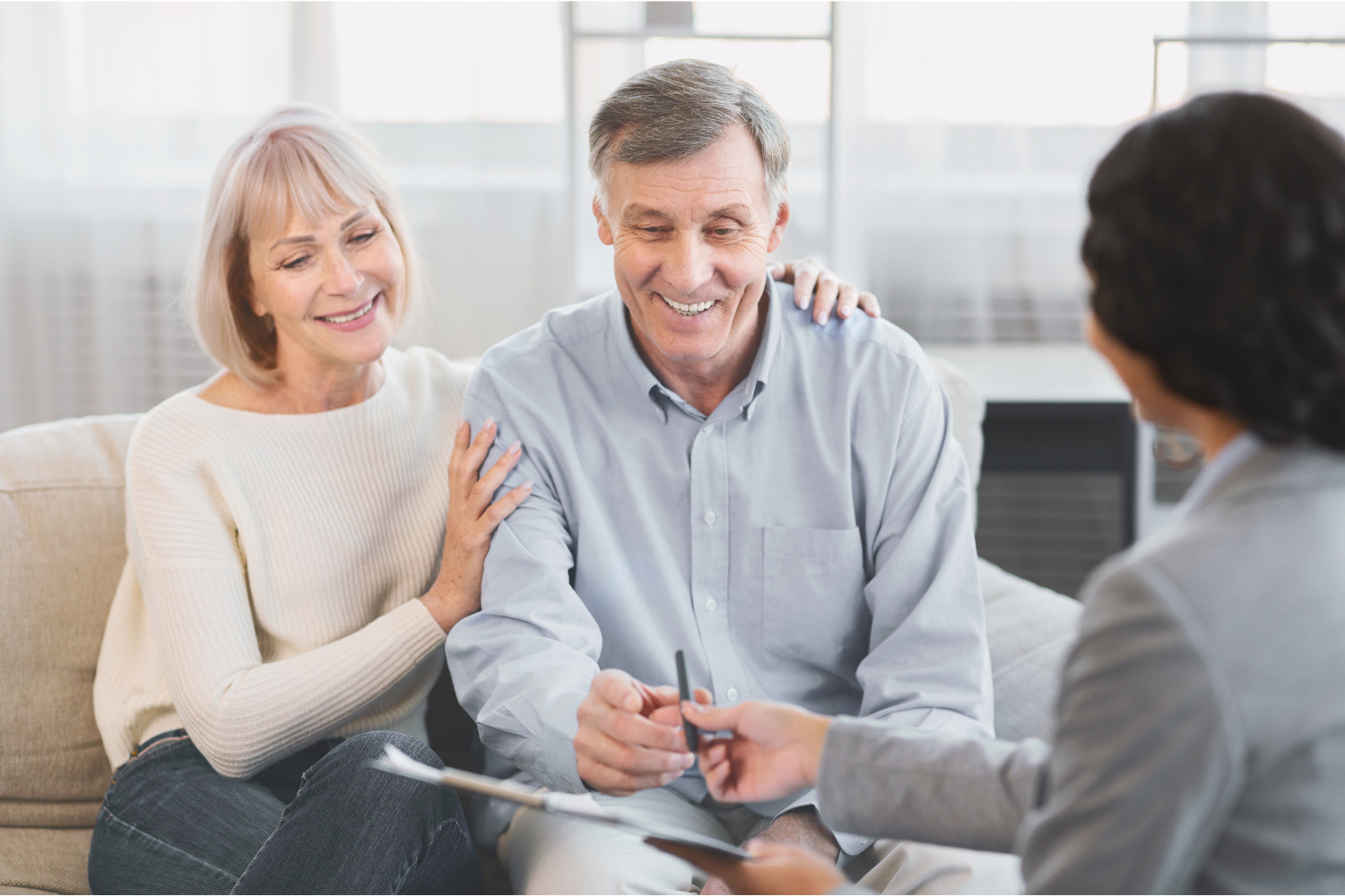 Couple meeting with a Medicare professional to discuss coverage options.