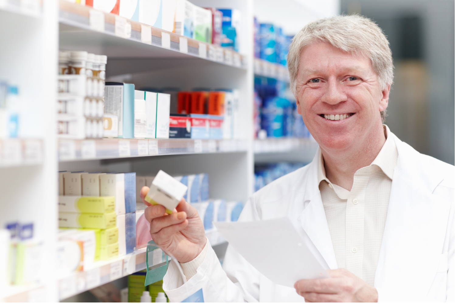 Pharmacist reviewing prescription medication and drug coverage.
