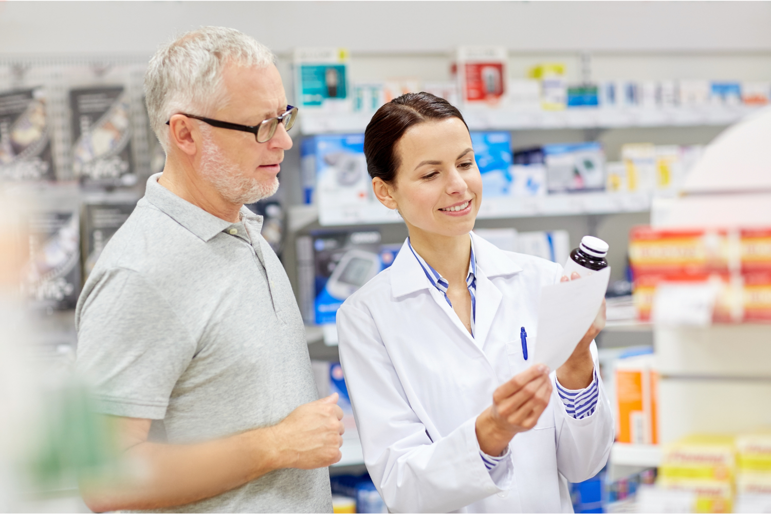 Pharmacist discussing prescription medication with a Medicare beneficiary.