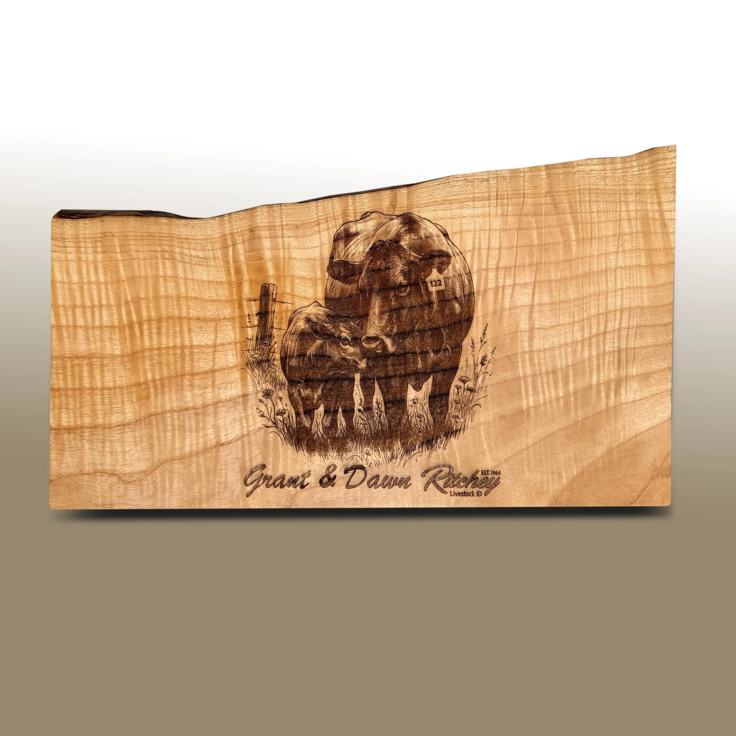 Wood plaque with engraved illustration of a cow and the text 'Grant & Dawn Richey Livestock ID'.