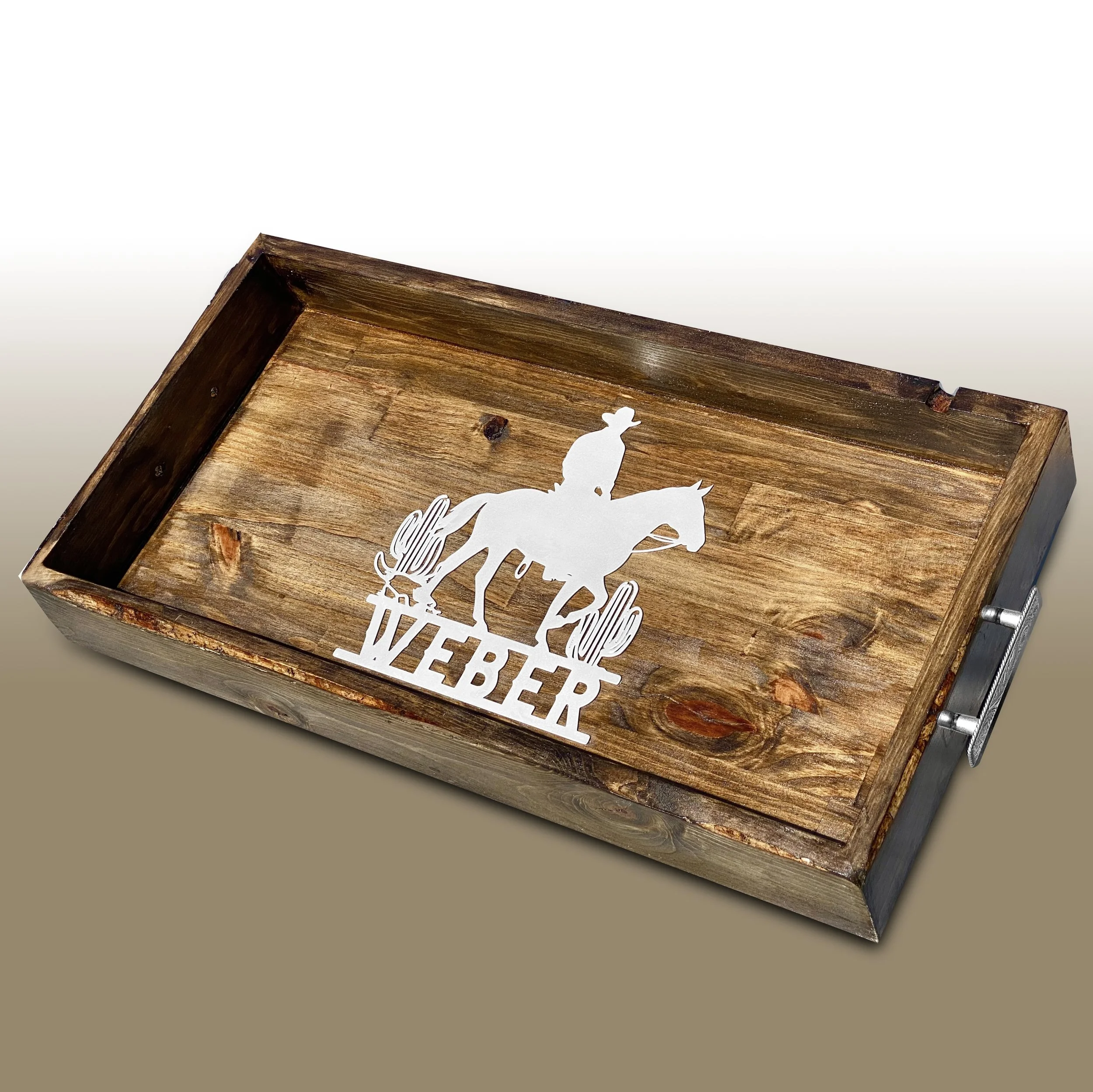 A wooden box with a cut-out silhouette of a cowboy riding a bucking horse, with the word "Rancher" intricately cut out below the cowboy.