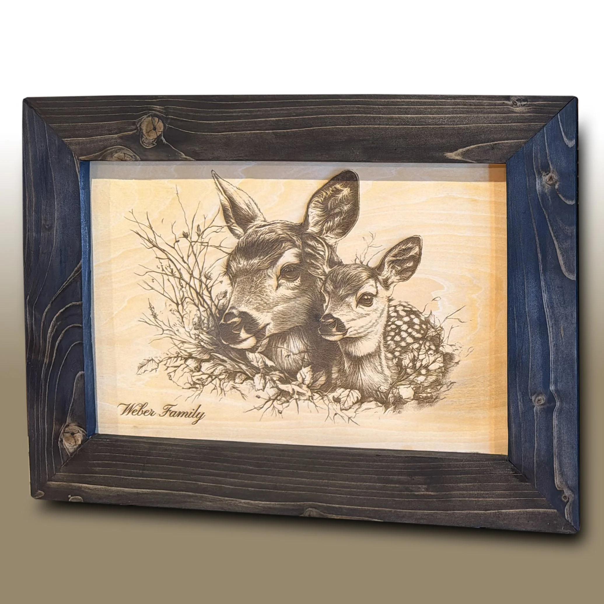 Wooden picture frame with illustrated deer and the text "Weber Family" at the bottom.