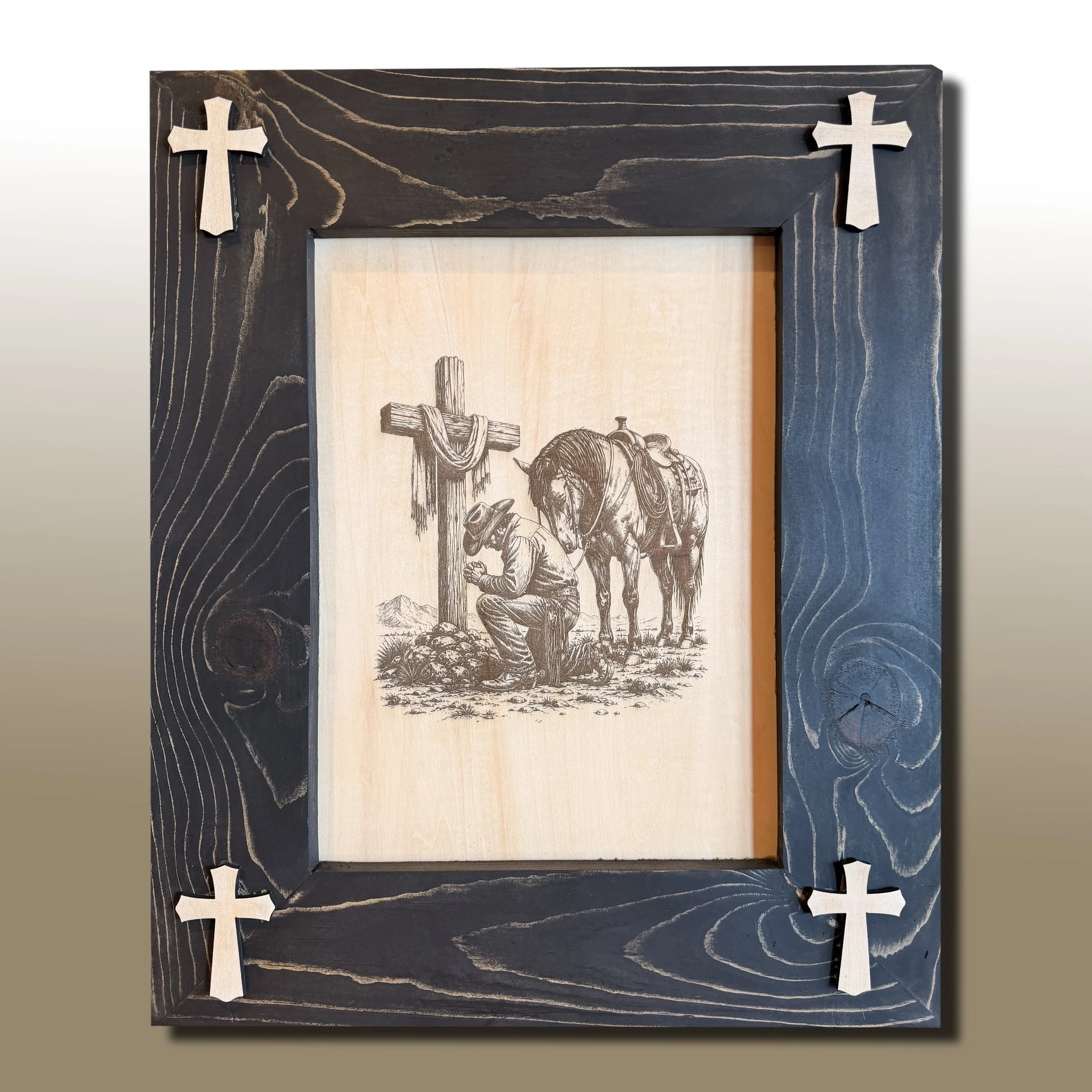 A black wooden picture frame with four wooden crosses, two on each side, mounted on the frame's top corners.