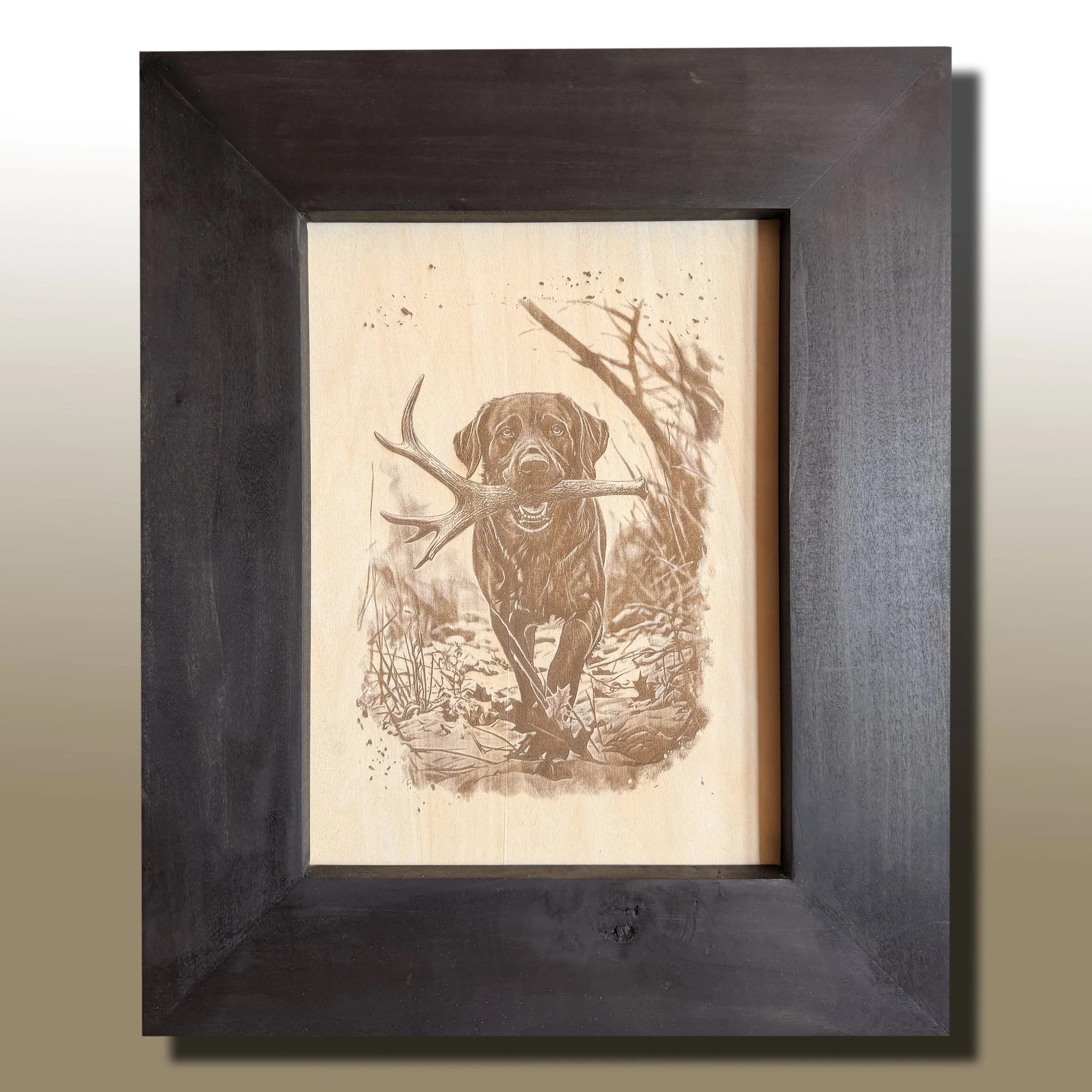 Framed artwork of a dog with antlers in a shadowy frame.