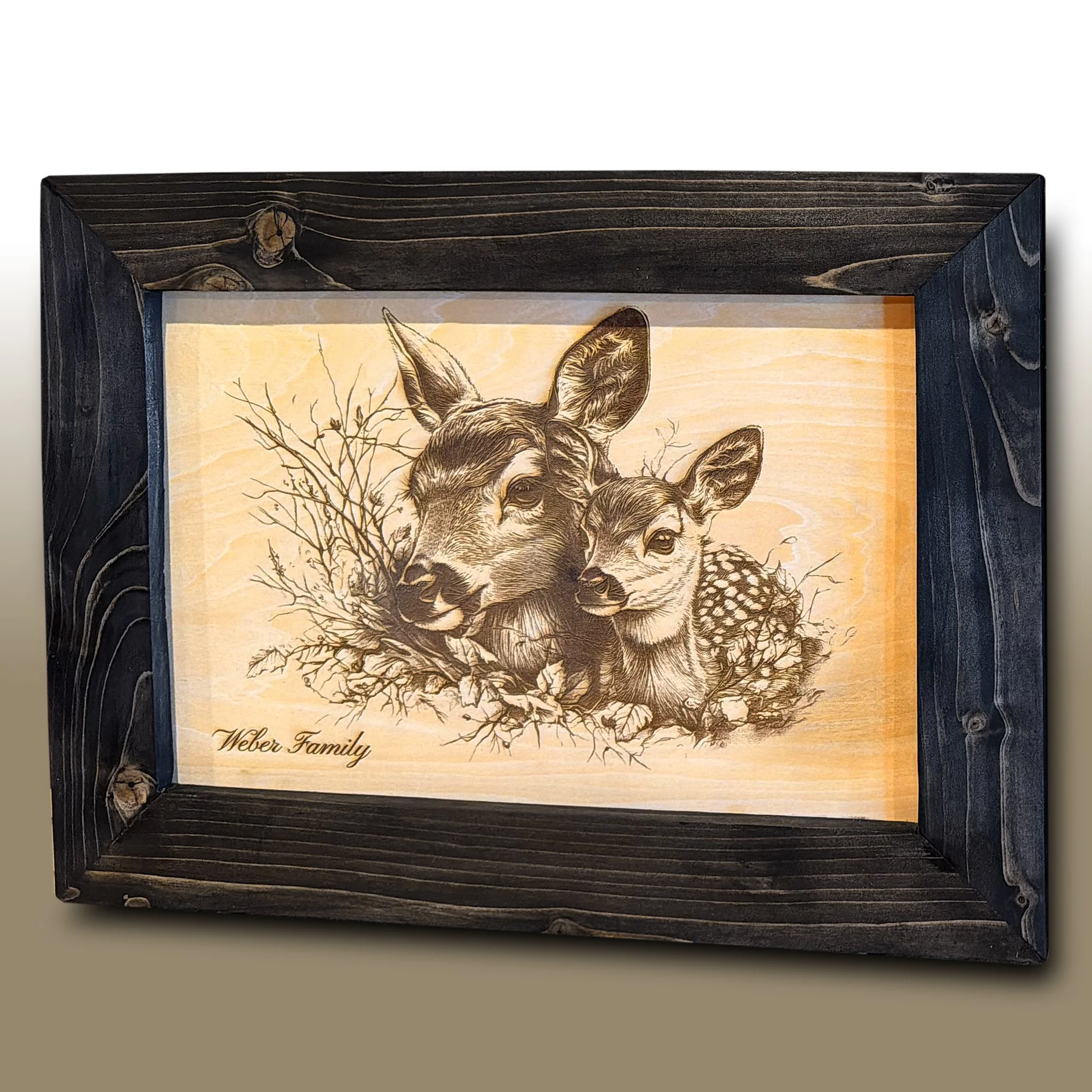 Wooden framed artwork featuring a detailed sketch of a deer and text reading 'Weber Family' at the bottom.