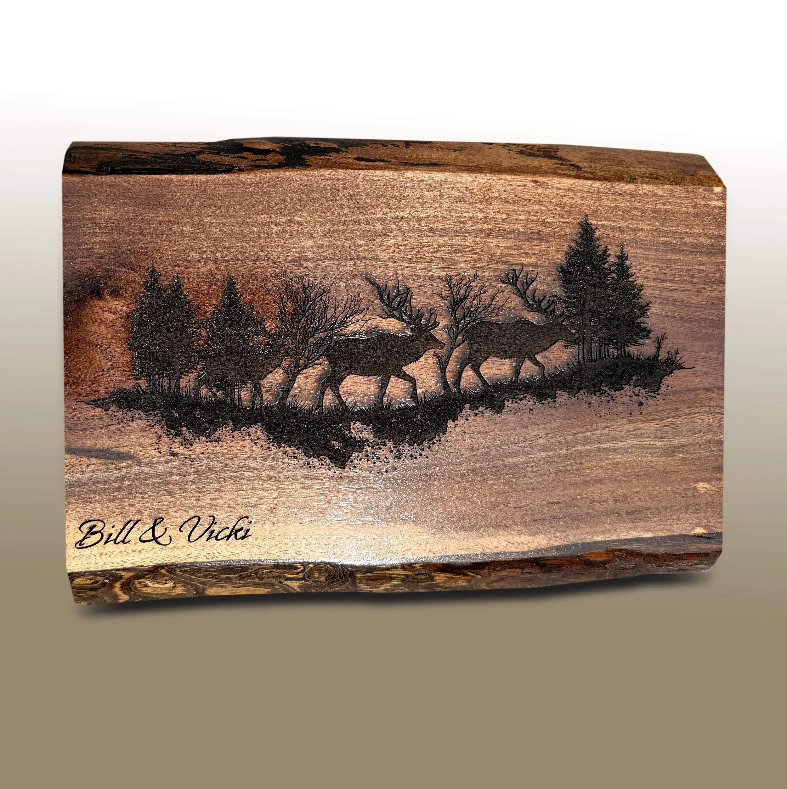 Wooden plaque with a sunset forest scene and engraved signature 'Bill & Vicki'