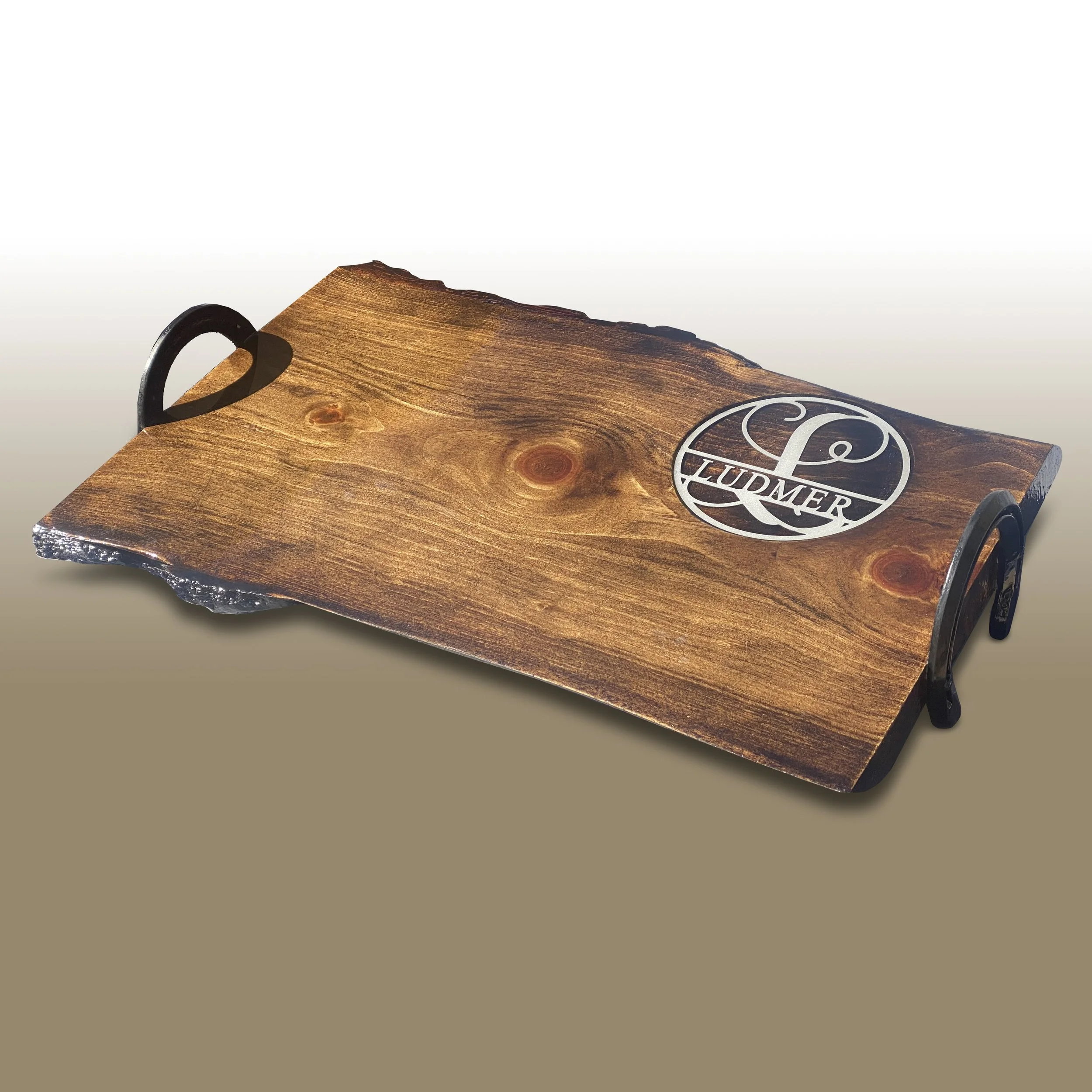 Close-up of a wooden Dreidel with black handles and London & Co. logo on top, on a plain neutral background.