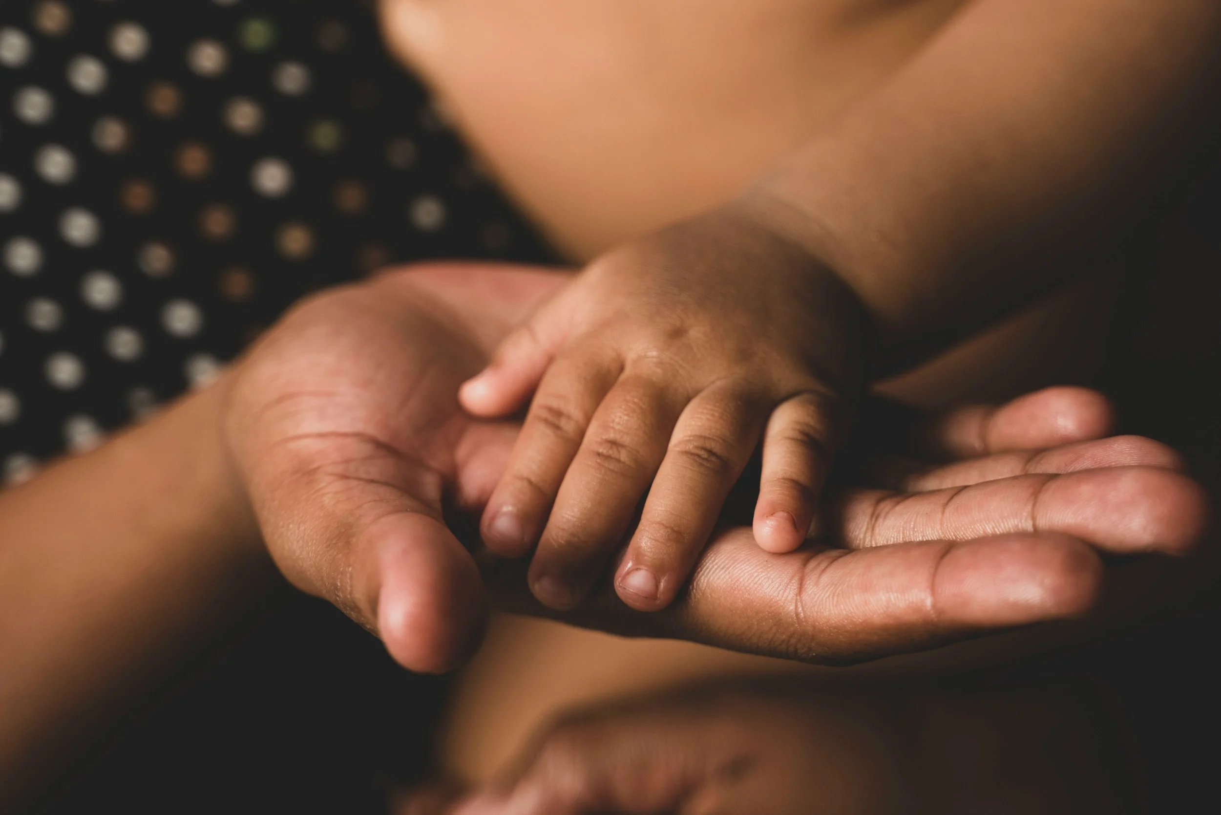 mother holding child's hand