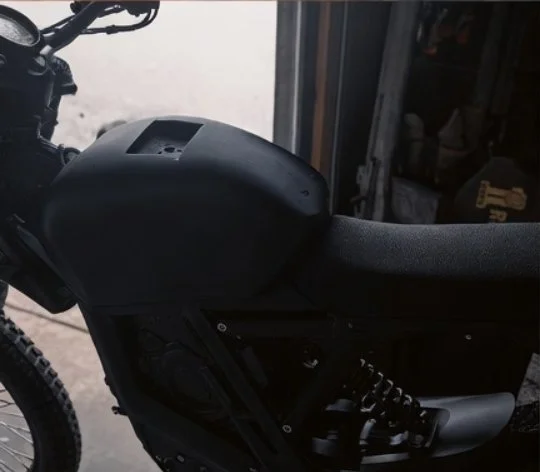 Close-up of a black mountain bike with a focus on the seat and rear suspension.