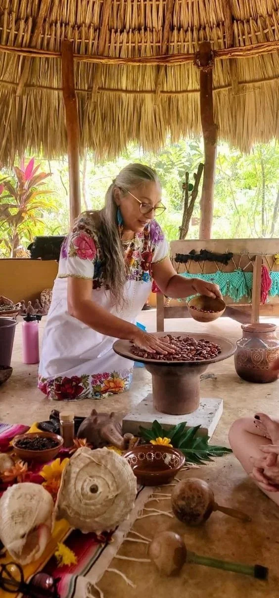 Maya spiritual guide leading a traditional cacao ceremony on sacred lands in Yucatán, México