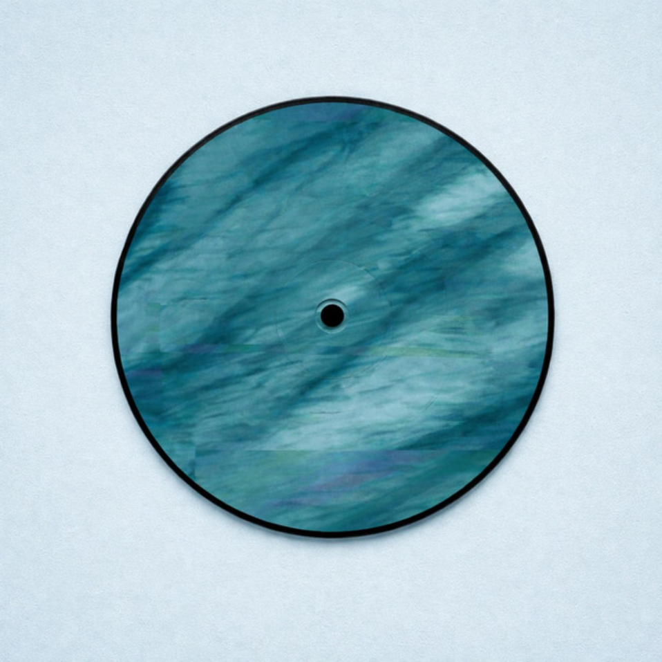 A circular object with a center hole, decorated with blue-green swirling patterns, mounted on a light-colored wall.