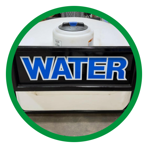 Sign with the word 'WATER' in blue and white letters, placed on a counter with a water purifier in the background.