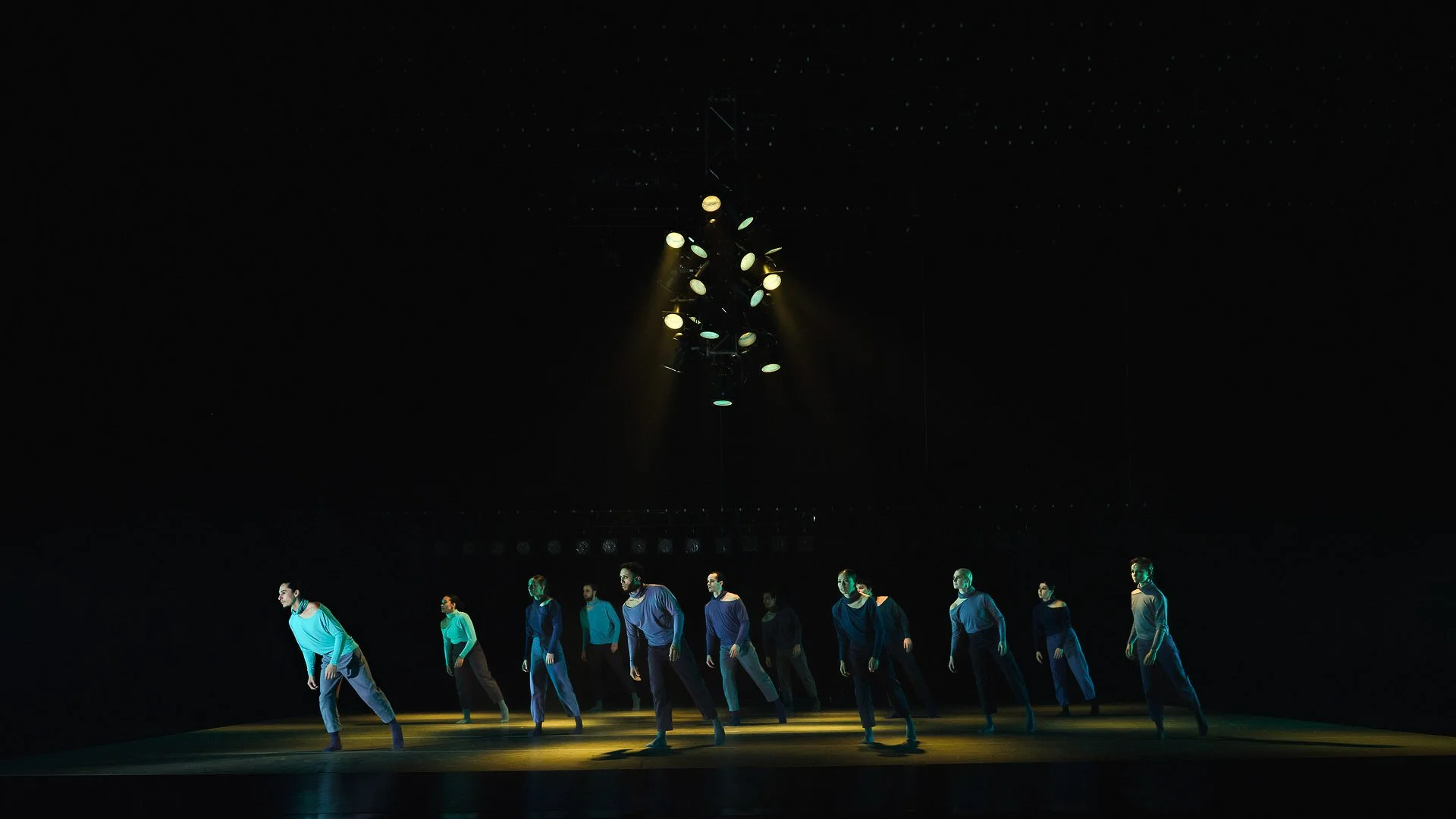 several dancers in performance, leaning to the left