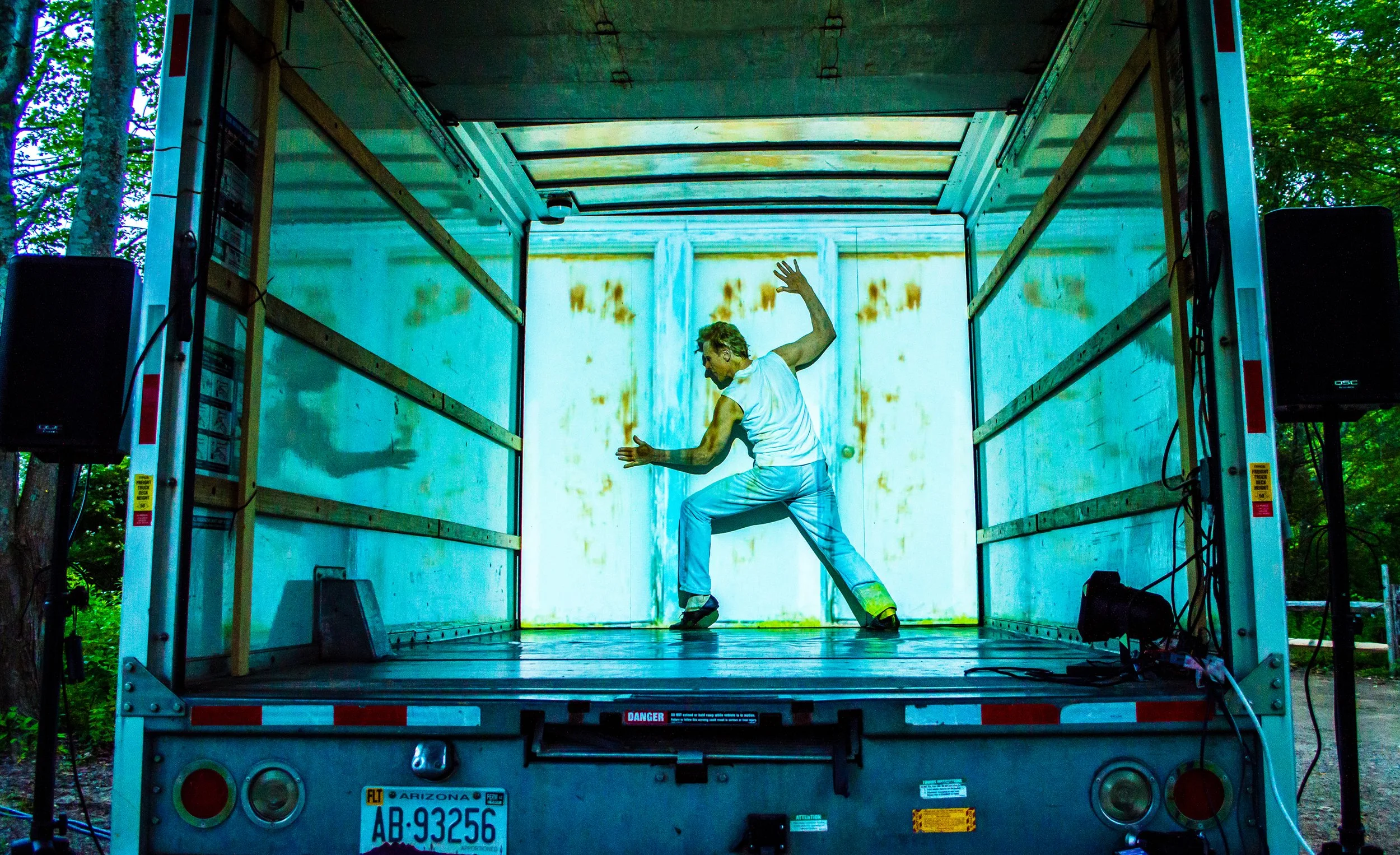 Art Bridgman performing inside trailer of a moving truck