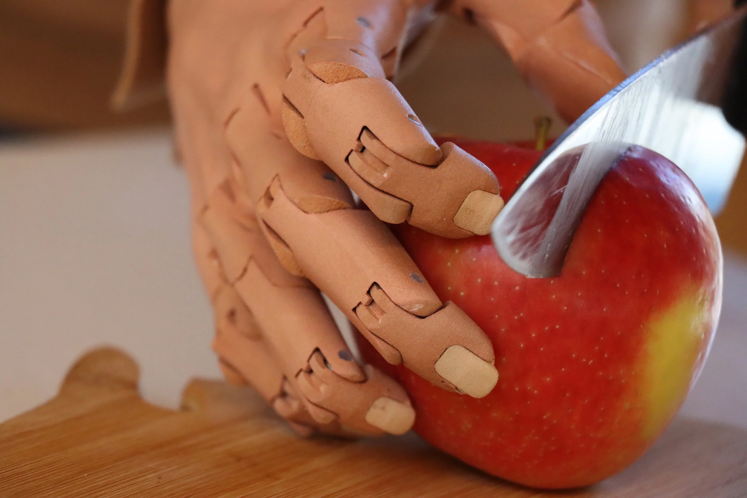 User cutting fruit with TrueLimb