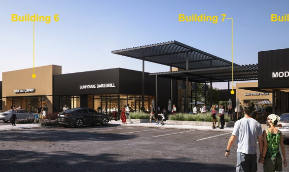 Shopping center with stores and a parking lot, people walking, black building with signage for Sunhouse Bar&Grill, and a large entrance canopy.