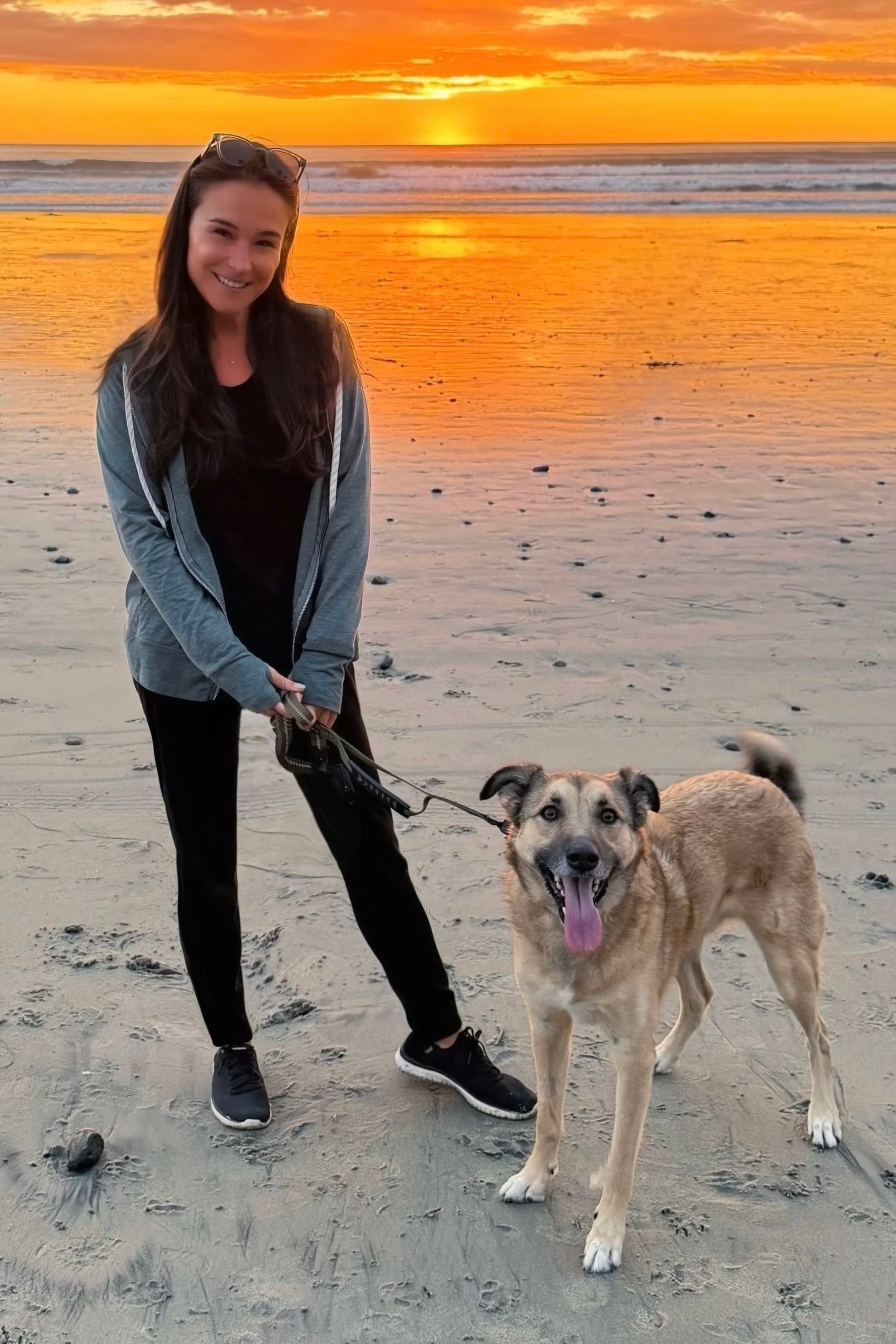 Andra Mocanu and Rafe at sunset — the bond at the heart of Unleashed Kinnection virtual dog training