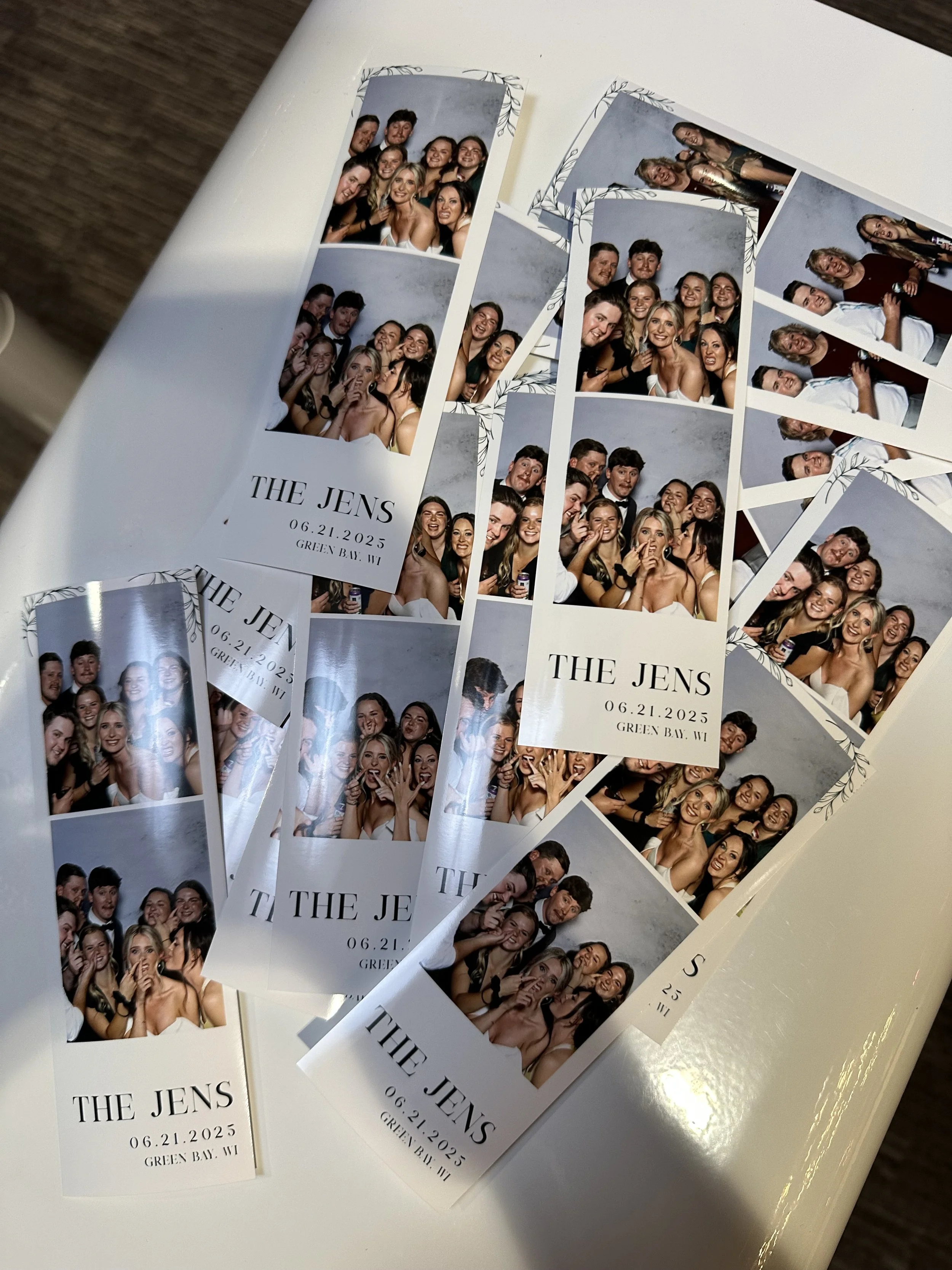 Several photo booth strips showing a group of people at a celebration, with the text 'THE JENS' and the date '06.21.2025', along with the location 'Green Bay, WI' on each strip.