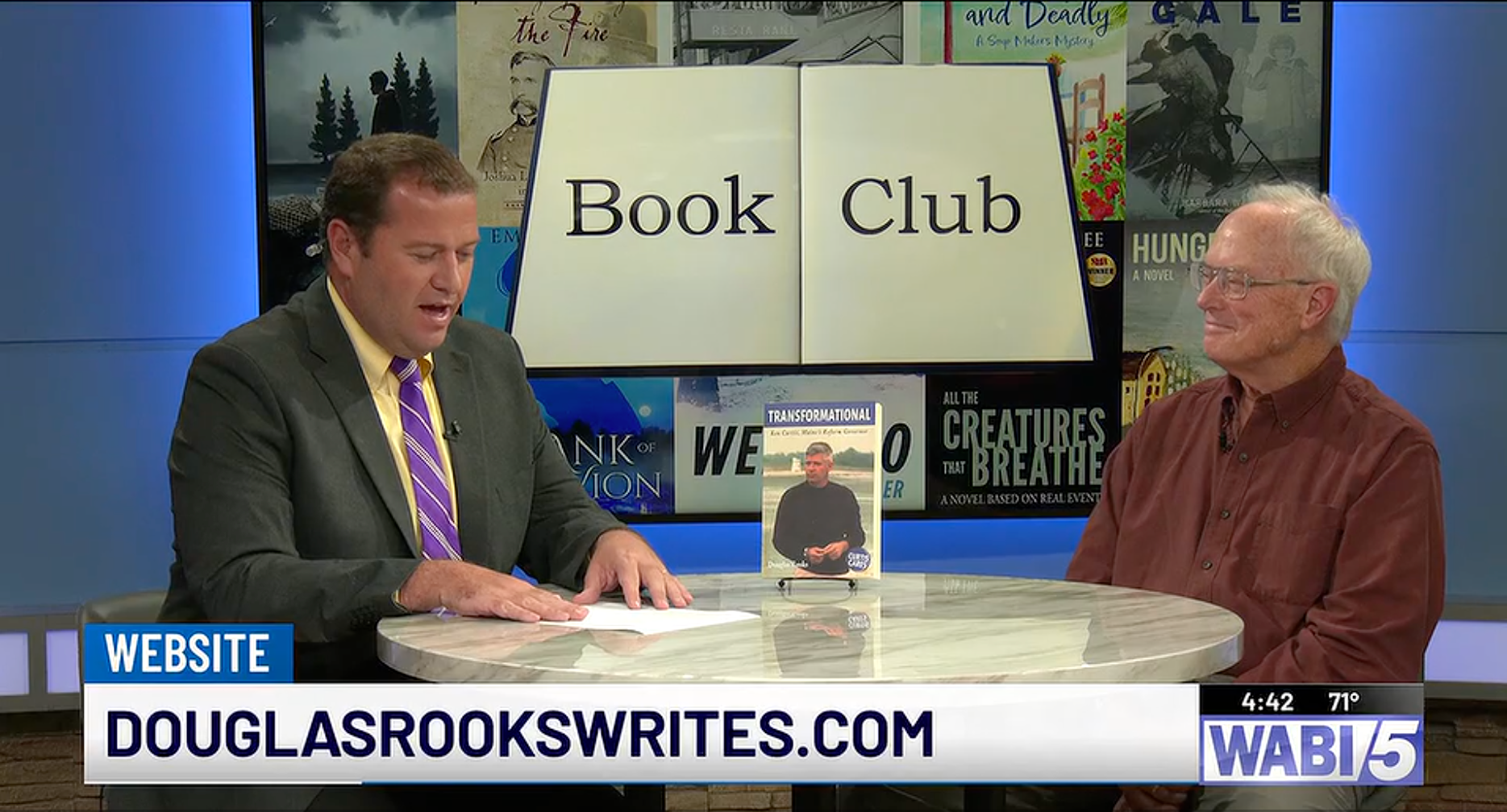 Douglas Rooks is interviewed on the WABI TV5 Book Club in Bangor by News Anchor Brian Sullivan(left). A copy of Doug's latest book, Transformational: Ken Curtis, Maine's Reform Governor, sits on the table between them.