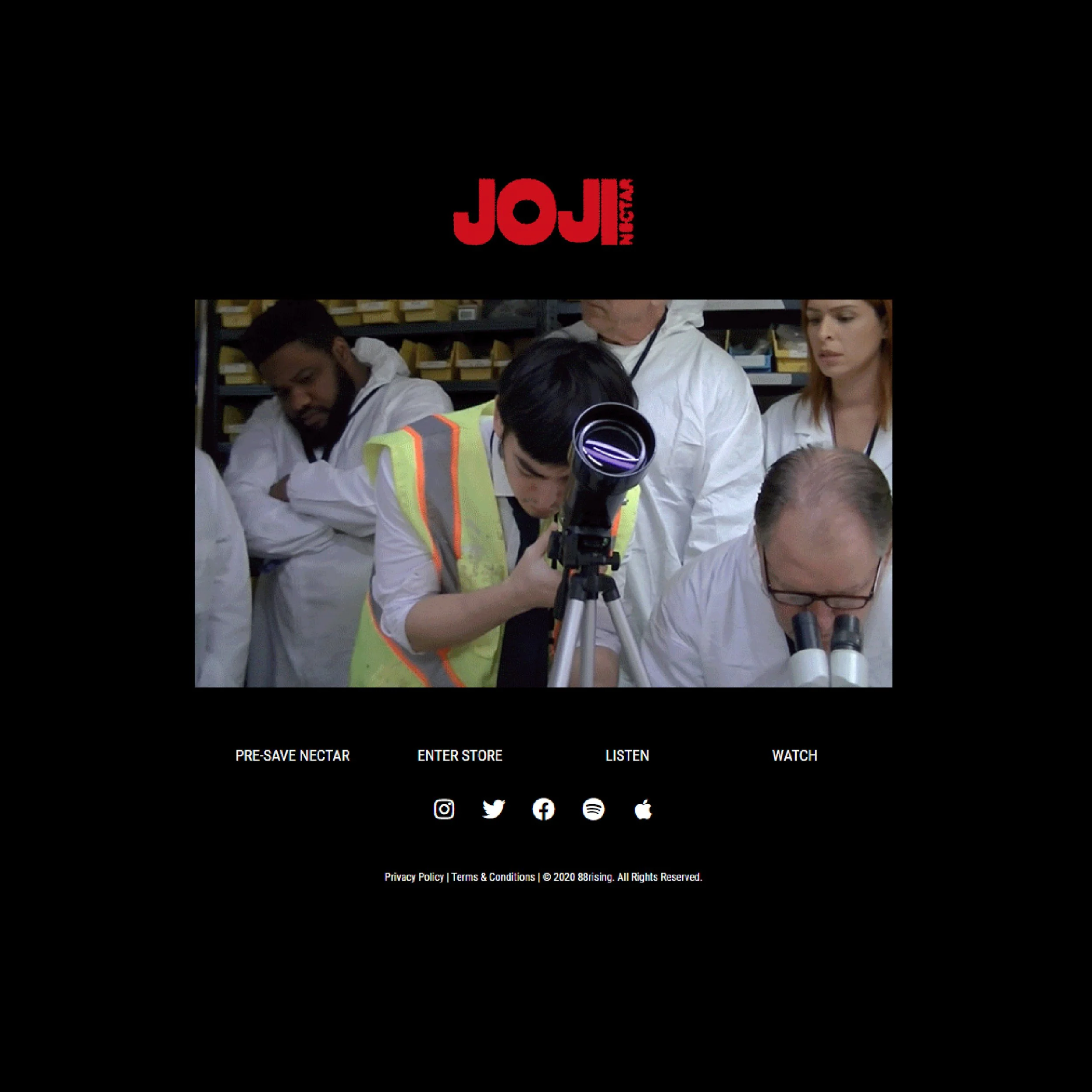 Screenshot of a website with a black background, red and white text, and a group of people in white coats looking at a microscope. The website has social media icons at the bottom and menu options labeled 'PRE-SAVE NECTAR,' 'ENTER STORE,' 'LISTEN,' a