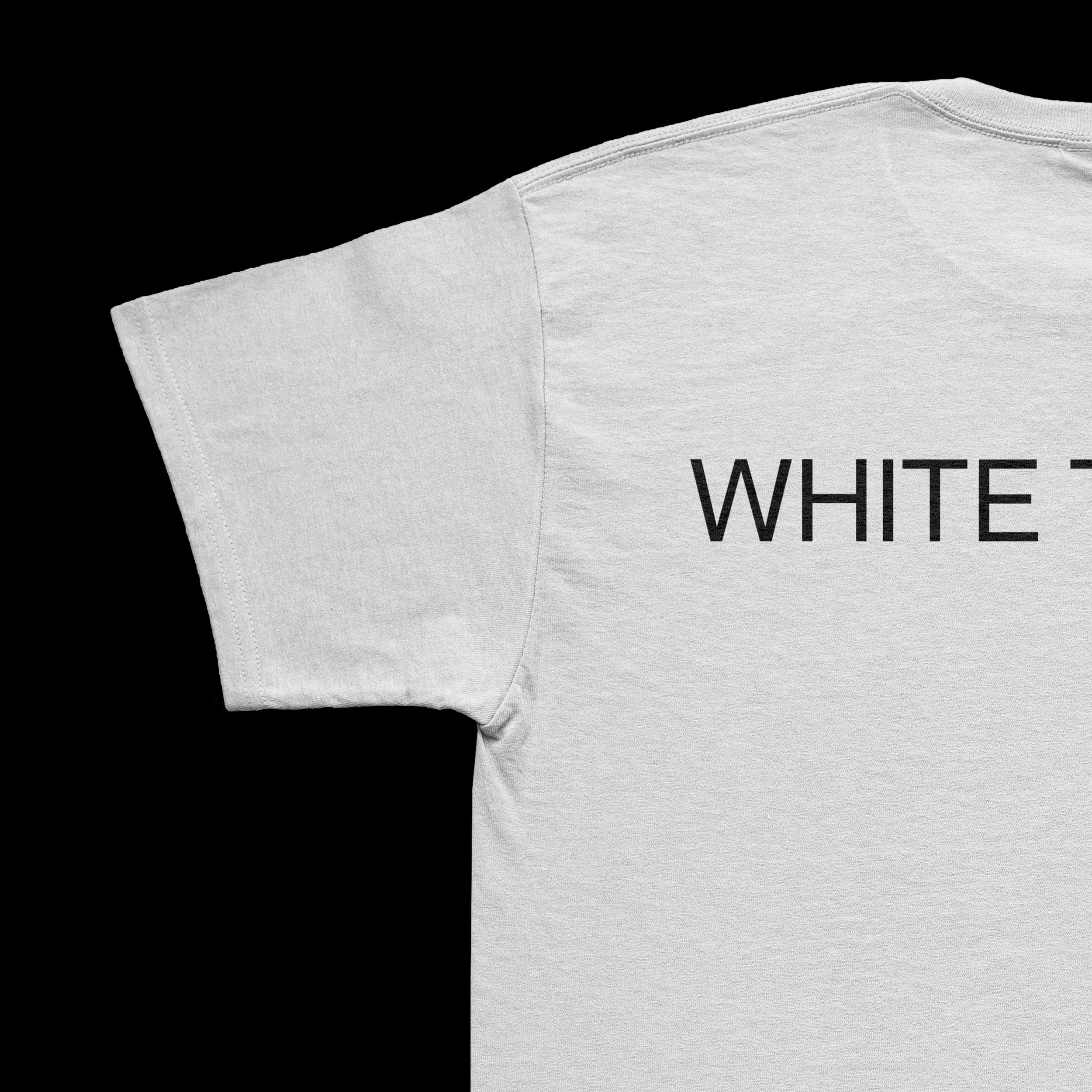 Close-up of a white T-shirt with black text on a black background.