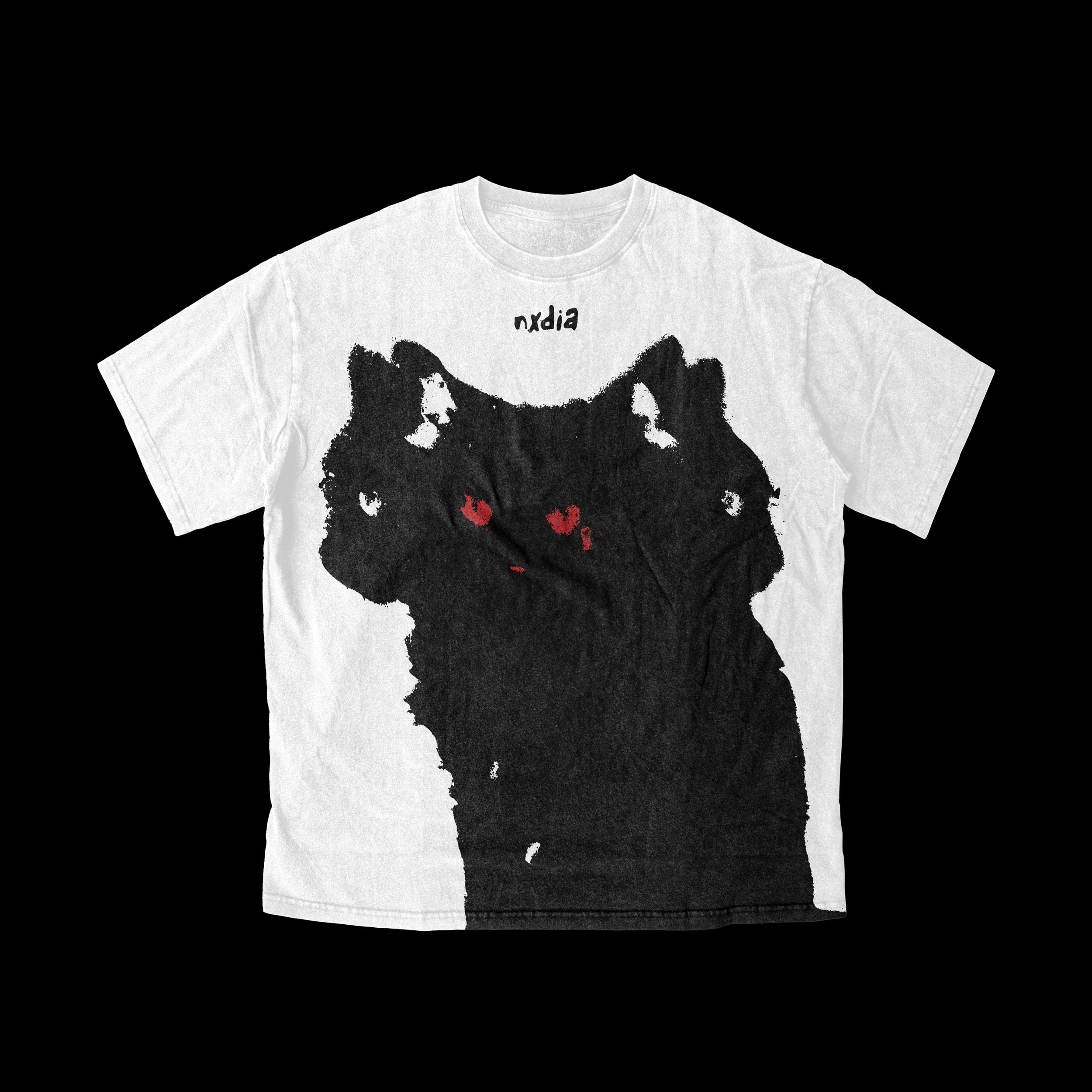 A white T-shirt with a black abstract dog face design and the word 'nxdia' above it.