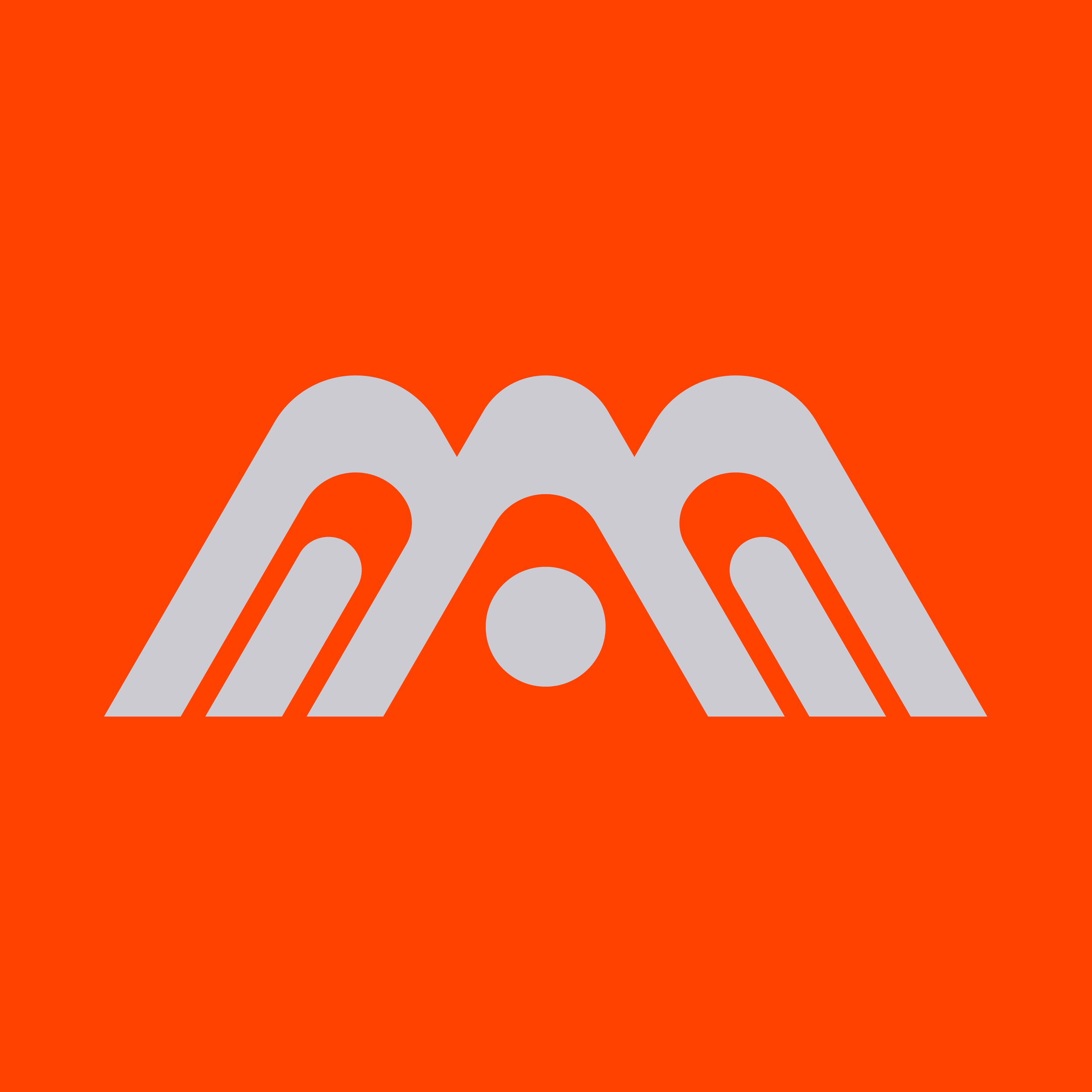 Close-up of an orange background with a gray mountain-shaped design and three circular holes at the bottom.