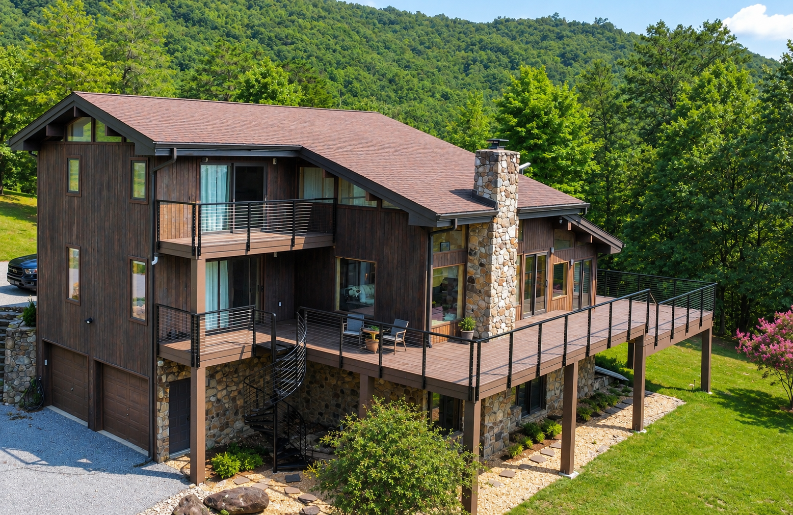 Custom multi-level mountain retreat featuring TimberTech AZEK decking, modern cable railing, integrated smart lighting, and a custom spiral staircase overlooking the Blue Ridge landscape.