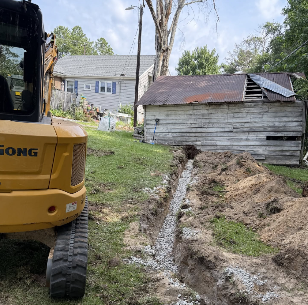 Drainage trench excavation with gravel installation for improved water runoff and drainage control